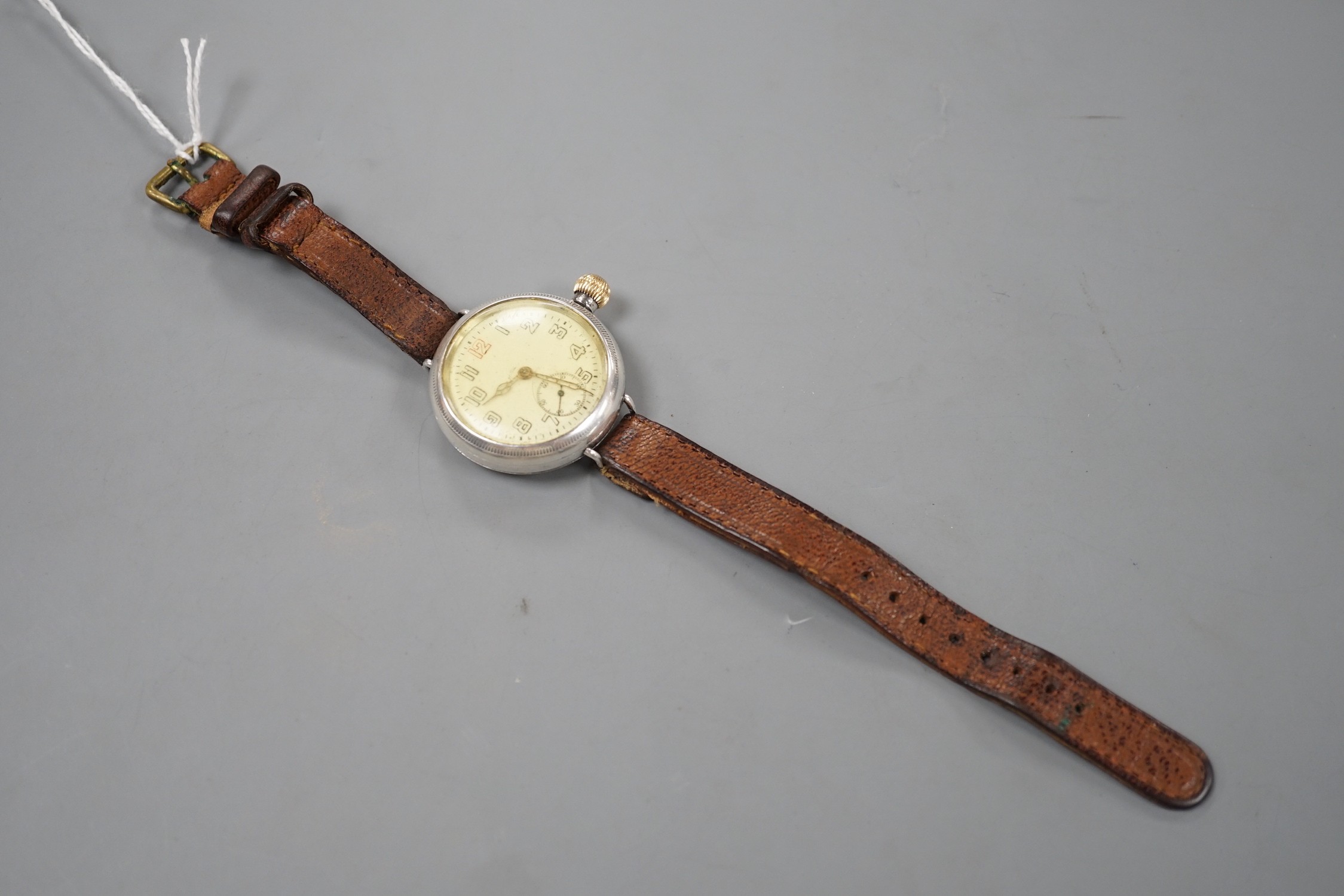A gentleman's early 20th century silver manual wind wrist watch with Zenith movement, on associated leather strap.